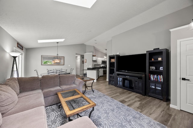 7838 Kiowa Way, Columbus, OH 43085 - living room with a skylight, lofted ceiling, and light wood finished floors