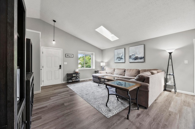 7838 Kiowa Way, Columbus, OH 43085 - living area featuring a skylight, vaulted ceiling, wood finished floors, and a textured ceiling