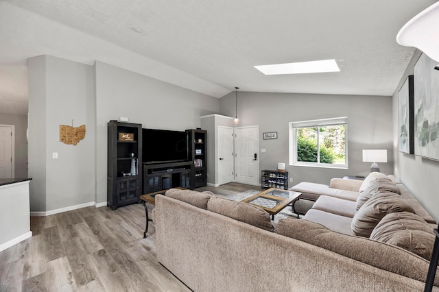 7838 Kiowa Way, Columbus, OH 43085 - living area featuring a skylight, wood finished floors, and lofted ceiling