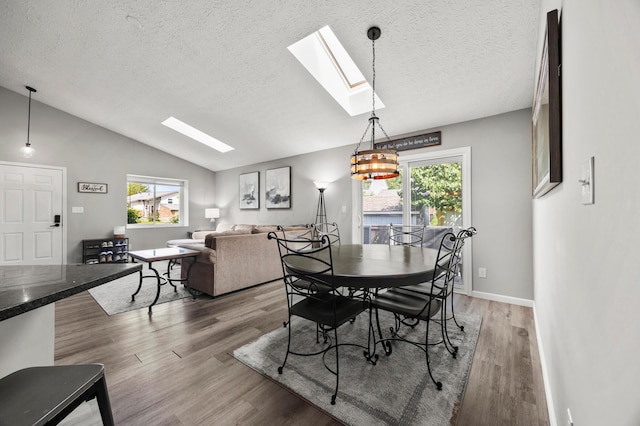 7838 Kiowa Way, Columbus, OH 43085 - dining room featuring a skylight, lofted ceiling, light wood-type flooring, and a textured ceiling