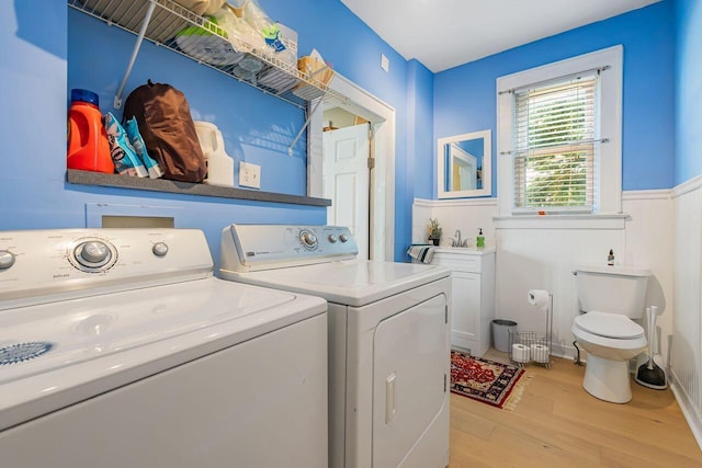 520 E Jenkins Ave, Columbus, OH 43207 - laundry area with washer and dryer, light wood-style flooring, and wainscoting