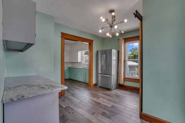 522 S Main St, New Lexington, OH 43764 - kitchen featuring freestanding refrigerator, a chandelier, and wood finished floors