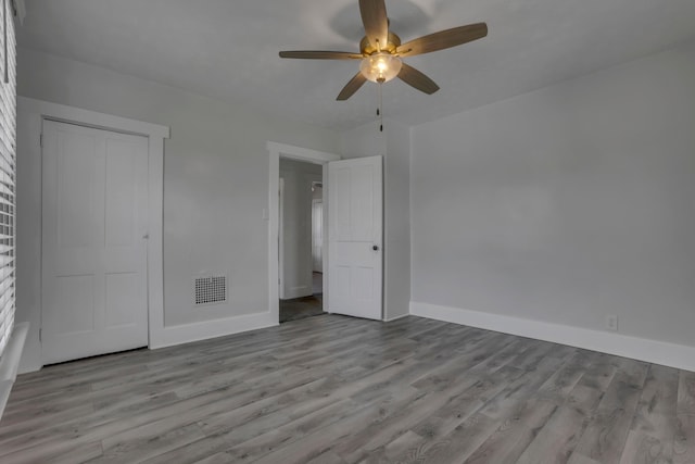 522 S Main St, New Lexington, OH 43764 - unfurnished bedroom featuring wood finished floors, a ceiling fan, and a closet