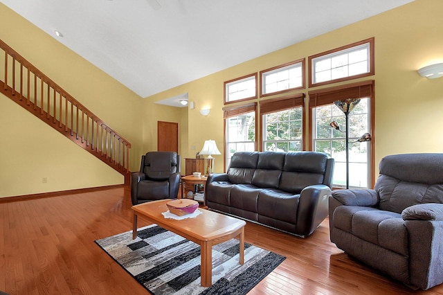 12961 Arabian Ct, Pickerington, OH 43147 - living area with high vaulted ceiling, wood finished floors, and stairway