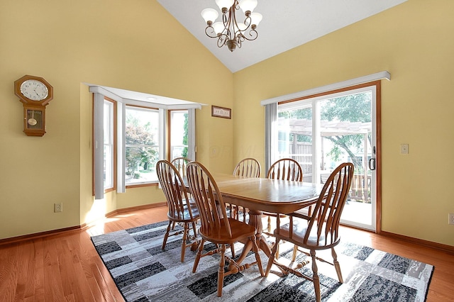 12961 Arabian Ct, Pickerington, OH 43147 - dining area with high vaulted ceiling, a chandelier, and light wood-type flooring