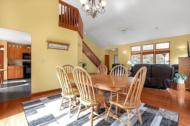 12961 Arabian Ct, Pickerington, OH 43147 - dining area featuring high vaulted ceiling, dark wood-type flooring, ceiling fan, and a chandelier