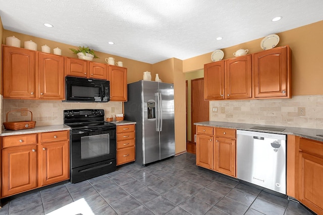 12961 Arabian Ct, Pickerington, OH 43147 - kitchen with black appliances, tasteful backsplash, light countertops, brown cabinetry, and a textured ceiling