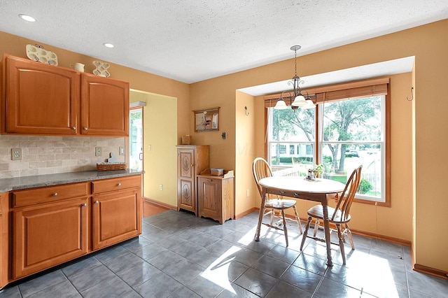 12961 Arabian Ct, Pickerington, OH 43147 - kitchen featuring a textured ceiling, backsplash, decorative light fixtures, light tile patterned floors, and recessed lighting