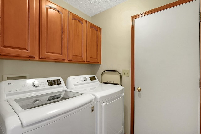 12961 Arabian Ct, Pickerington, OH 43147 - washroom featuring separate washer and dryer, cabinet space, and a textured ceiling