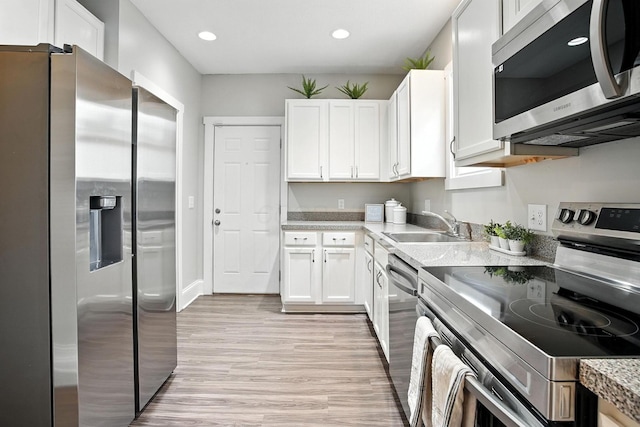 628 Reinhard Ave, Columbus, OH 43206 - kitchen featuring appliances with stainless steel finishes, white cabinets, recessed lighting, and light wood-style flooring