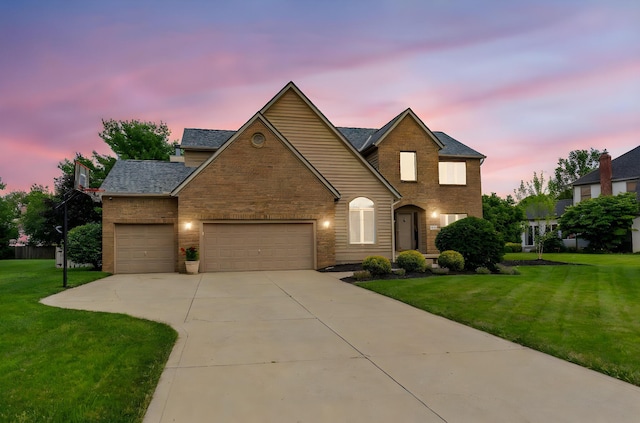 13191 Brandon Cir, Pickerington, OH 43147 - traditional-style house with a garage, a front lawn, driveway, and brick siding