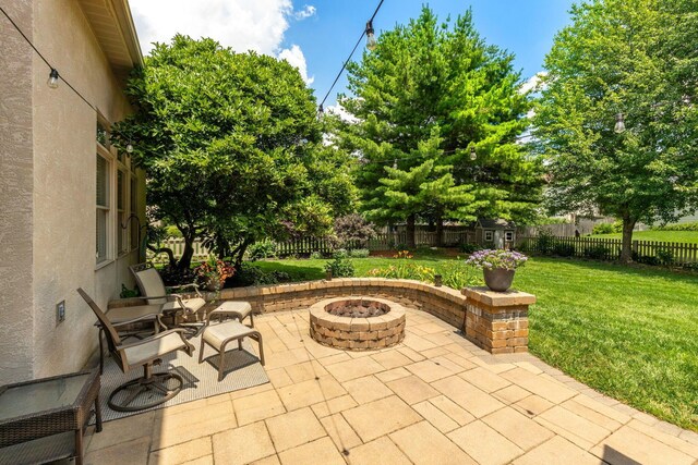 13191 Brandon Cir, Pickerington, OH 43147 - fenced backyard featuring a fire pit, a patio area, and a shed