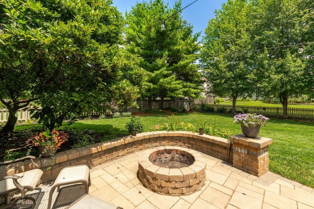 13191 Brandon Cir, Pickerington, OH 43147 - fenced backyard featuring a patio area and an outdoor fire pit