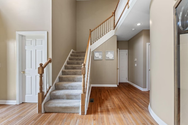 13191 Brandon Cir, Pickerington, OH 43147 - stairway featuring hardwood / wood-style floors and a towering ceiling