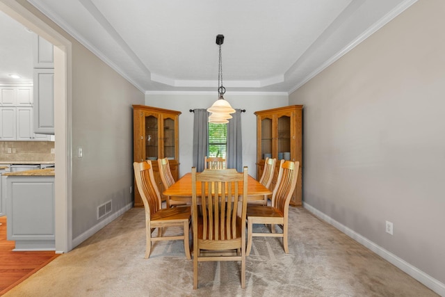 13191 Brandon Cir, Pickerington, OH 43147 - dining area with a tray ceiling, ornamental molding, and light colored carpet