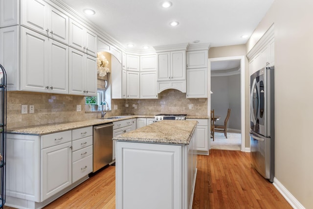 13191 Brandon Cir, Pickerington, OH 43147 - kitchen with stainless steel appliances, a center island, white cabinetry, light wood finished floors, and recessed lighting