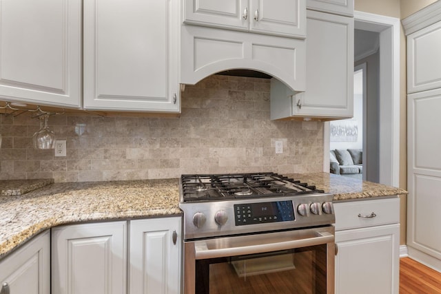 13191 Brandon Cir, Pickerington, OH 43147 - kitchen with stainless steel range with gas stovetop, white cabinets, tasteful backsplash, and light stone counters