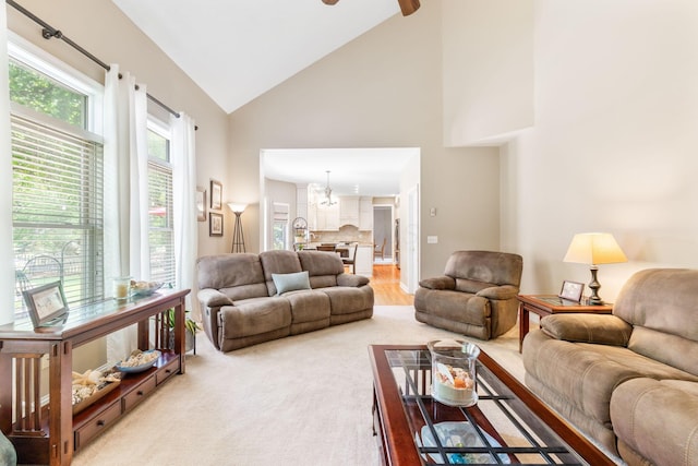 13191 Brandon Cir, Pickerington, OH 43147 - living area with high vaulted ceiling, a chandelier, and light colored carpet