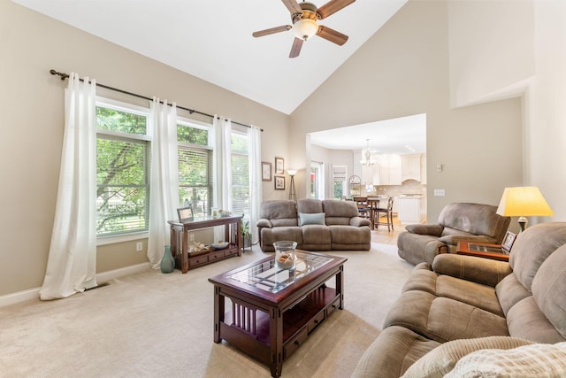13191 Brandon Cir, Pickerington, OH 43147 - living room with a ceiling fan, a chandelier, high vaulted ceiling, and light colored carpet