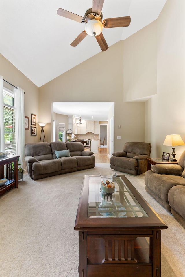 13191 Brandon Cir, Pickerington, OH 43147 - living room featuring carpet floors, high vaulted ceiling, a chandelier, and a ceiling fan