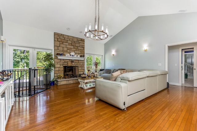 1800 Lynnbrook Ct, Orient, OH 43146 - living area with french doors, a chandelier, light wood-type flooring, high vaulted ceiling, and a fireplace