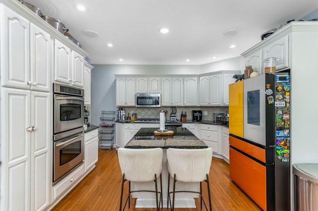 1800 Lynnbrook Ct, Orient, OH 43146 - kitchen featuring stainless steel appliances, white cabinets, light wood-type flooring, tasteful backsplash, and recessed lighting