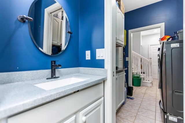 1800 Lynnbrook Ct, Orient, OH 43146 - bathroom featuring washer / dryer, vanity, and tile patterned flooring