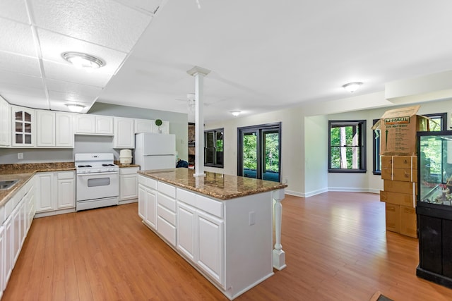 1800 Lynnbrook Ct, Orient, OH 43146 - kitchen with white appliances, a kitchen island, light wood-style floors, and glass insert cabinets