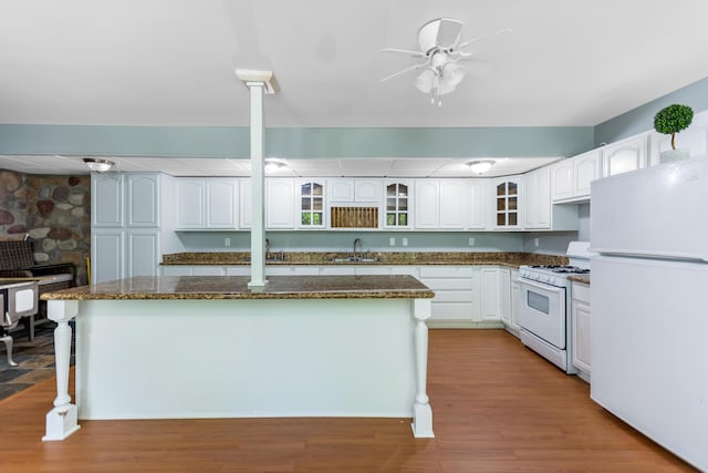 1800 Lynnbrook Ct, Orient, OH 43146 - kitchen featuring white appliances, a center island, a ceiling fan, white cabinetry, and glass insert cabinets