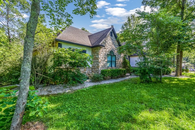 1800 Lynnbrook Ct, Orient, OH 43146 - view of property exterior featuring stone siding, roof with shingles, a yard, and stucco siding