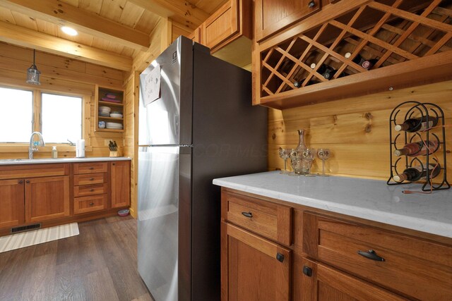 1607 Kato Ln, Sugar Grove, OH 43155 - kitchen with freestanding refrigerator, brown cabinetry, dark wood-style floors, light countertops, and beam ceiling
