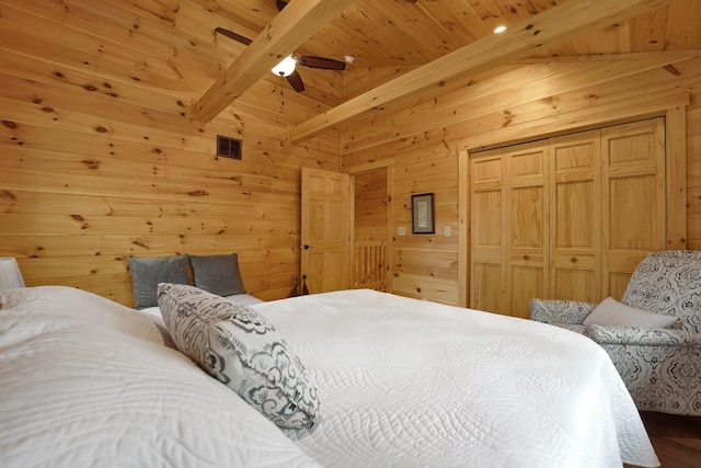 1607 Kato Ln, Sugar Grove, OH 43155 - bedroom with a wood ceiling with exposed beams, wood walls, wood finished floors, a closet, and a ceiling fan