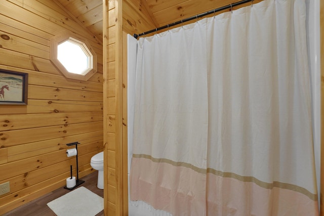 1607 Kato Ln, Sugar Grove, OH 43155 - full bath with wooden walls, wood finished floors, vaulted ceiling, and curtained shower