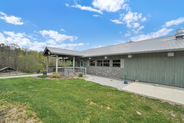 1607 Kato Ln, Sugar Grove, OH 43155 - back of property featuring a yard, covered porch, a metal roof, and stone siding