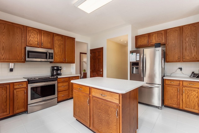 5630 Dorshire Dr, Galena, OH 43021 - kitchen featuring stainless steel appliances, tasteful backsplash, light countertops, and brown cabinetry