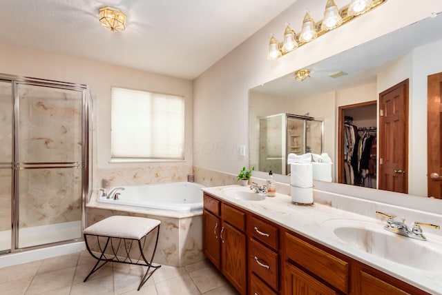 5630 Dorshire Dr, Galena, OH 43021 - bathroom featuring double vanity, a shower stall, a garden tub, tile patterned floors, and a walk in closet