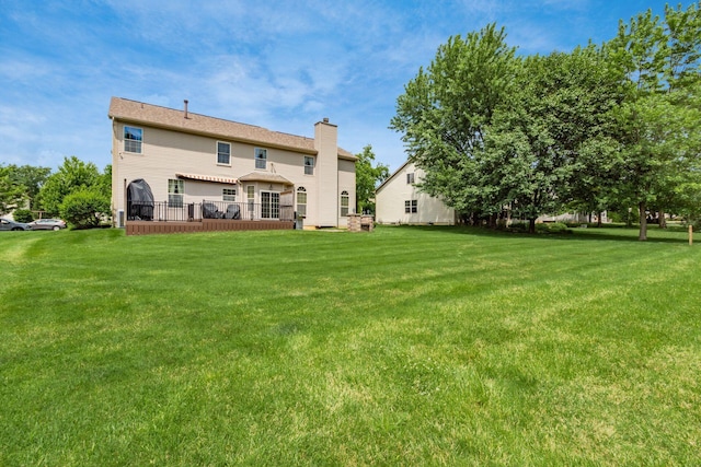 5630 Dorshire Dr, Galena, OH 43021 - rear view of house featuring a chimney, a yard, and a wooden deck