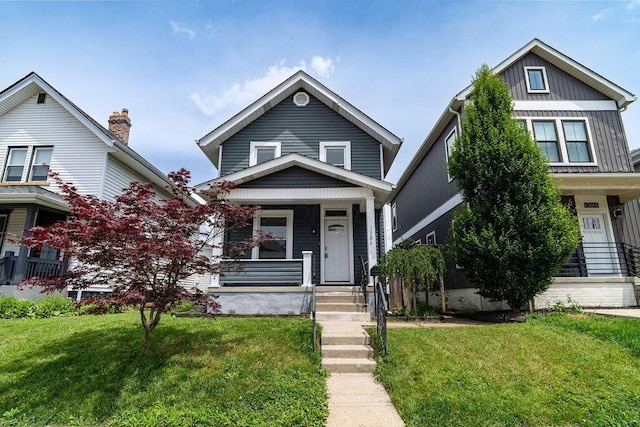 1382 S 5th St, Columbus, OH 43207 - view of front facade with covered porch, a front lawn, and board and batten siding