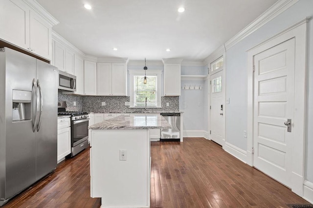 1382 S 5th St, Columbus, OH 43207 - kitchen featuring appliances with stainless steel finishes, white cabinets, backsplash, dark wood-style flooring, and ornamental molding