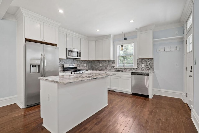 1382 S 5th St, Columbus, OH 43207 - kitchen featuring appliances with stainless steel finishes, decorative backsplash, light stone countertops, white cabinetry, and dark wood-style flooring