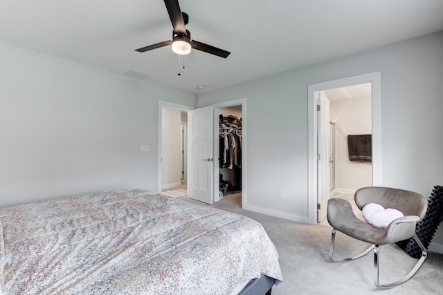 225 Messenger Way, Lewis Center, OH 43035 - bedroom with a walk in closet, light carpet, a closet, connected bathroom, and ceiling fan