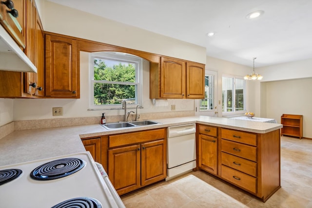 6750 Schreiner St E, Worthington, OH 43085 - kitchen featuring dishwasher, under cabinet range hood, a peninsula, brown cabinetry, and recessed lighting