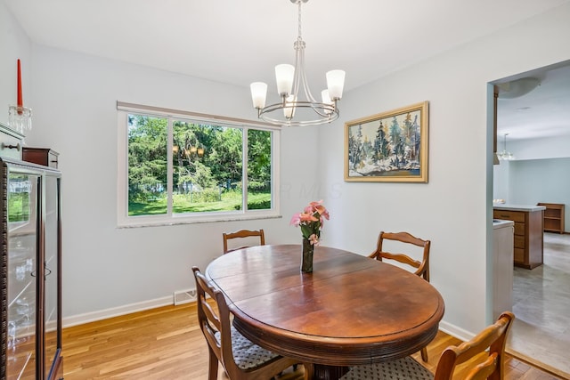 6750 Schreiner St E, Worthington, OH 43085 - dining room with a chandelier and light wood-style floors