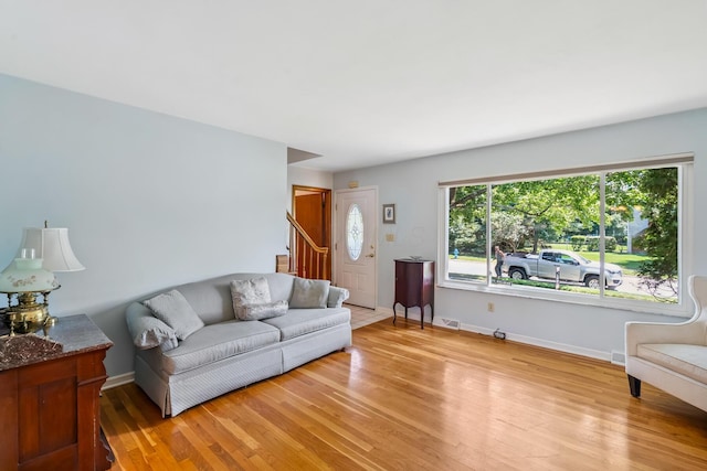 6750 Schreiner St E, Worthington, OH 43085 - living room featuring light wood finished floors and stairway