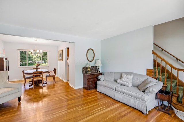6750 Schreiner St E, Worthington, OH 43085 - living room with light wood-style floors, a chandelier, and stairway
