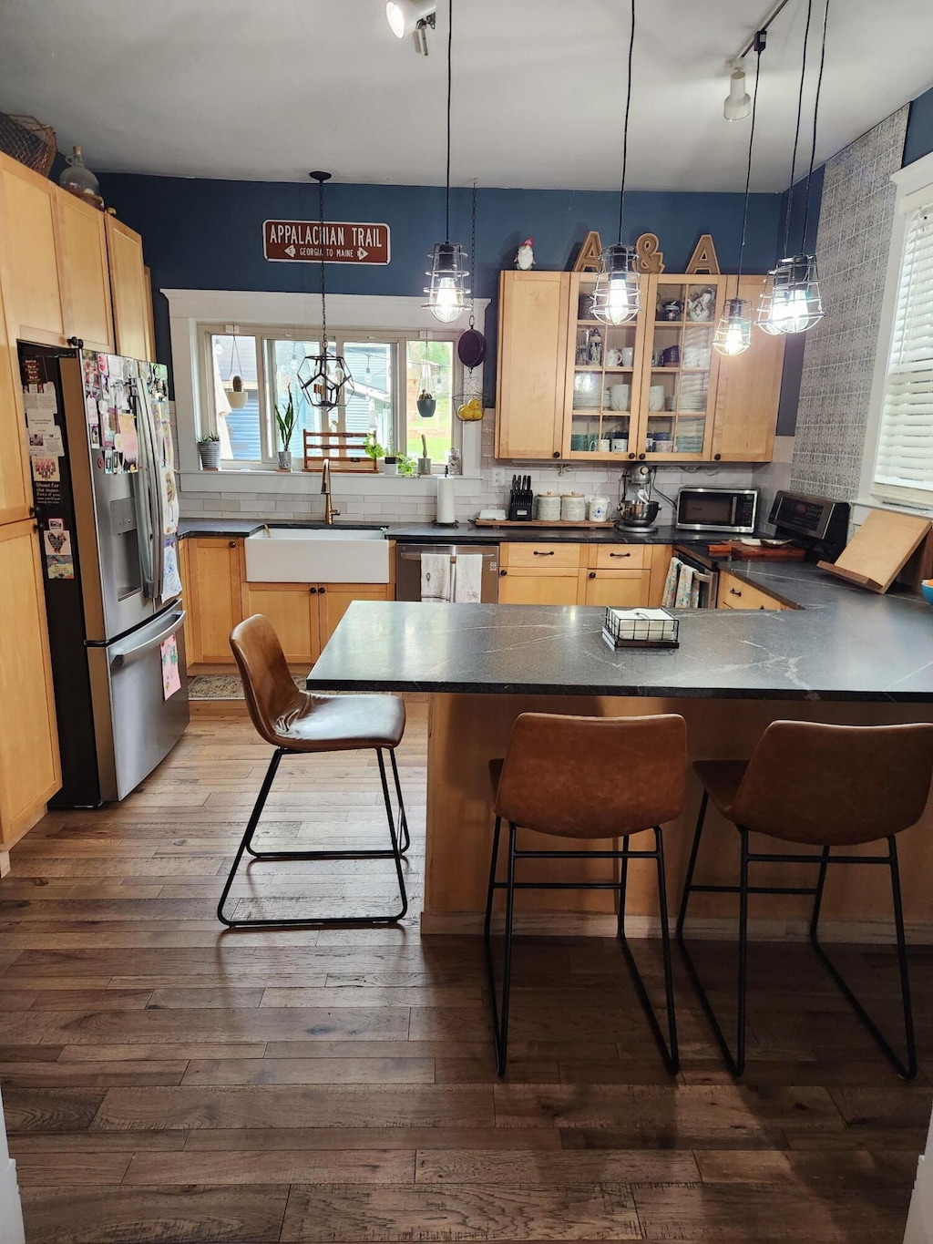 1183 N Columbus St, Lancaster, OH 43130 - kitchen featuring appliances with stainless steel finishes, rail lighting, light brown cabinets, and a peninsula