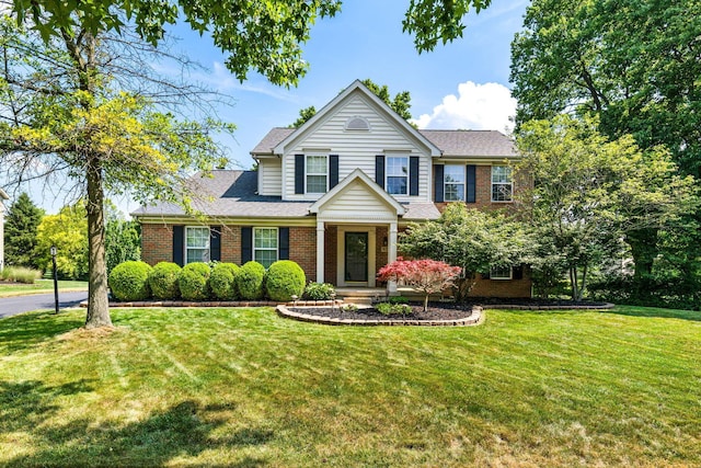 7672 Tullymore Dr, Dublin, OH 43016 - traditional-style home with brick siding, a front yard, and roof with shingles
