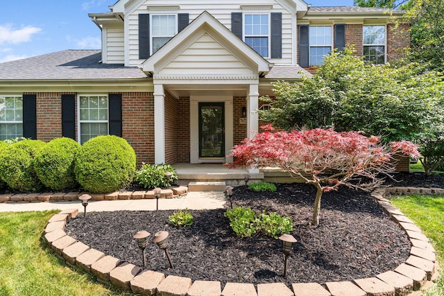7672 Tullymore Dr, Dublin, OH 43016 - view of front of house featuring brick siding, a porch, and a shingled roof