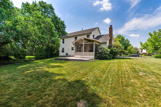 7672 Tullymore Dr, Dublin, OH 43016 - back of house featuring a sunroom, a chimney, a yard, and a patio area
