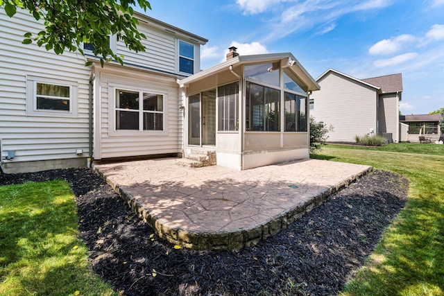7672 Tullymore Dr, Dublin, OH 43016 - back of house featuring a patio, a sunroom, a yard, and a chimney